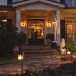 Black wrought iron front door with circular glass panel shown alongside 2pk garden light shepherd hook for outdoor lighting