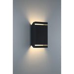 Black outdoor wall light fixture on a gray wall
