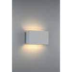 Square wall-mounted light fixture on a gray wall
