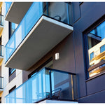 Modern building exterior with glass balconies and windows