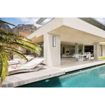 Modern house with pool and outdoor furniture under a clear sky