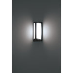 Wall-mounted outdoor light fixture on a gray wall