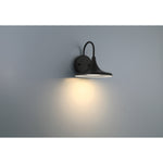 Black wall-mounted light fixture on a gray wall
