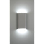 Modern wall-mounted light fixture on a gray wall