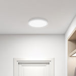 Ceiling light fixture in a room with white walls and a door.