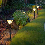 Black solar-powered premier garden pathway lights with warm glowing lantern-style fixtures in 3100K or 6000K
