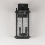 Black outdoor wall light fixture with textured glass on a white background