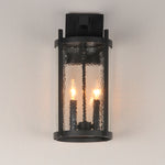 Black outdoor wall light fixture with glass cover on a neutral background