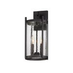 Black outdoor wall light fixture with clear glass on a white background