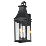 Black outdoor wall lantern with clear glass on a white background