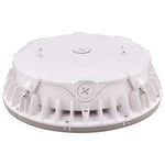A white circular electronic device with a ribbed outer base and a flat top cover, photographed on a clean white background.