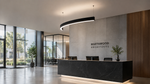 Modern office lobby reception area with a black marble front desk, a gray stone wall featuring the text 'NORTHWOOD ARCHITECTS', wood slat wall paneling, and large windows with outdoor greenery.