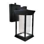 A black outdoor wall lantern light fixture with a textured clear glass shade, shown against a plain white background.