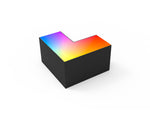 Black l-shaped rgbw beam connector with vibrant rainbow-colored illuminated top surface in a sleek architectural design