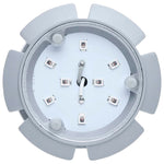 Light gray gear-like object with a white center on a white background