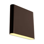 A modern rectangular wall sconce light fixture in a bronze finish, shown at an angle with its warm yellow light illuminated against a plain white background.