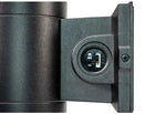 Close-up detail of a black cylindrical device with a side-mounted circular port or connector on a white background.