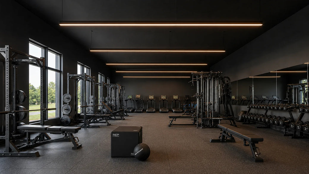 LED RGBW linear fixtures lighting the main training floor of a modern fitness center