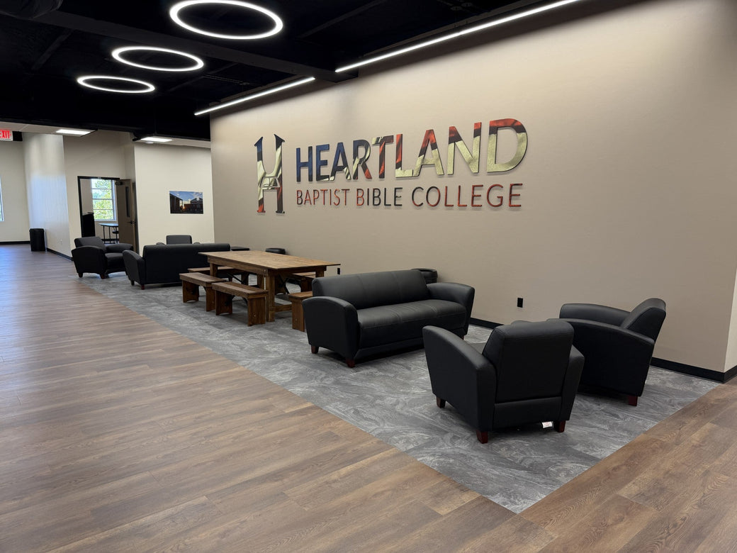 Illuminated 48-inch LED round pendant rings with black housings above a college student commons seating area