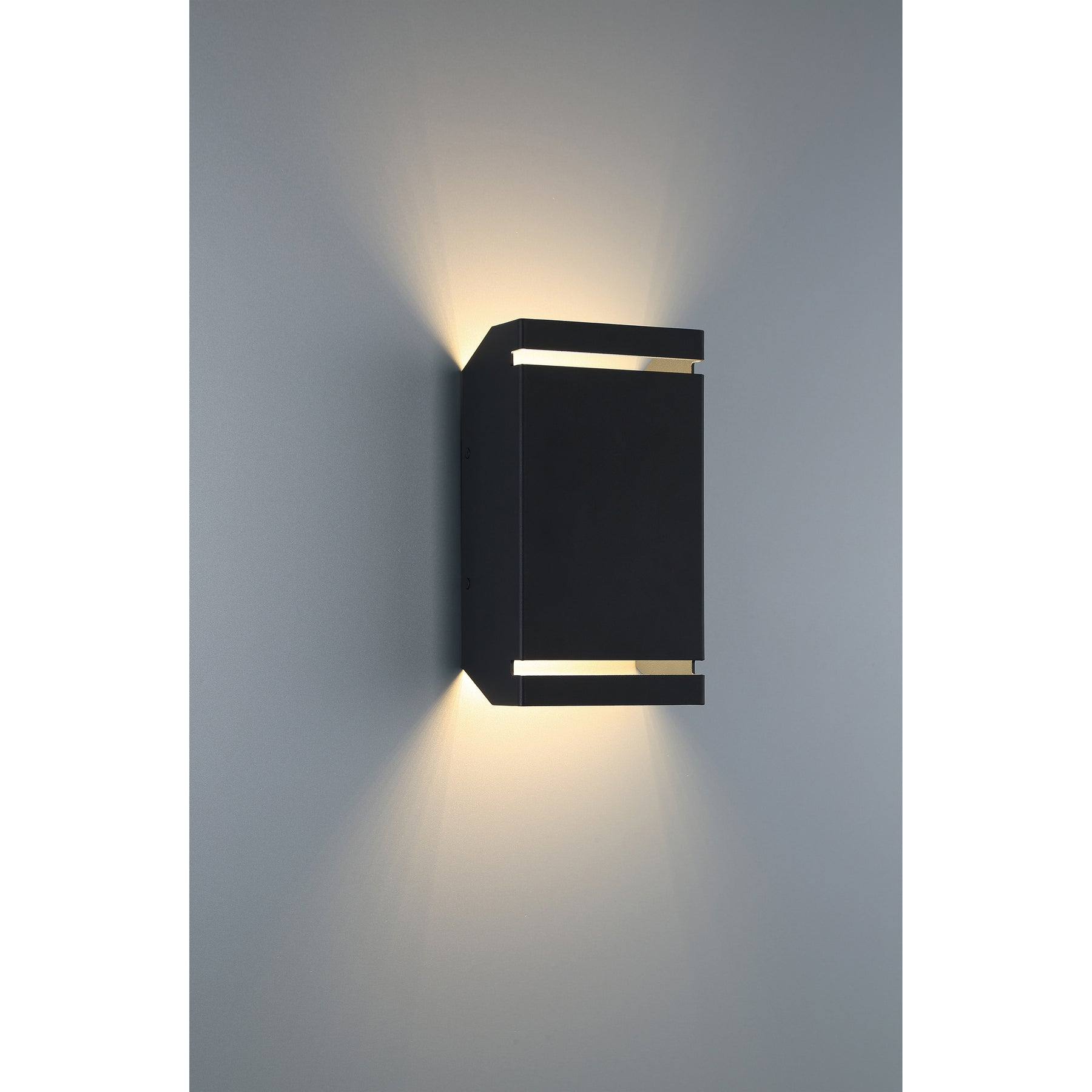 Black outdoor wall light fixture on a gray wall