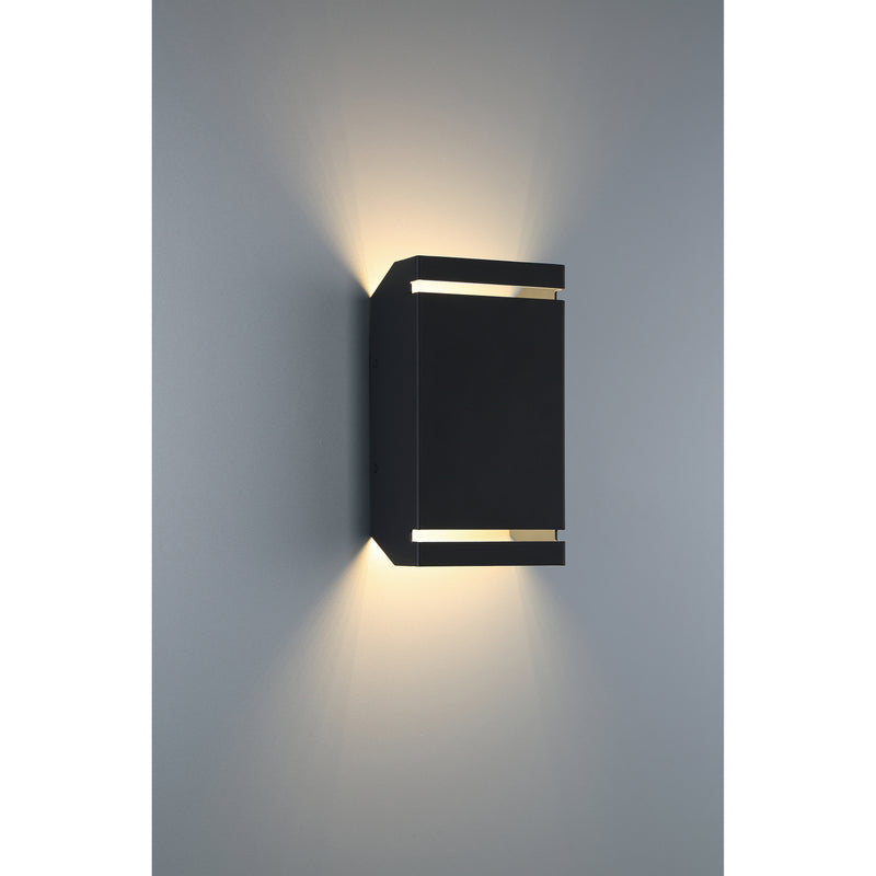 Black outdoor wall light fixture on a gray wall