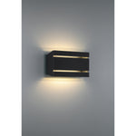 Black outdoor wall light fixture on a gray wall