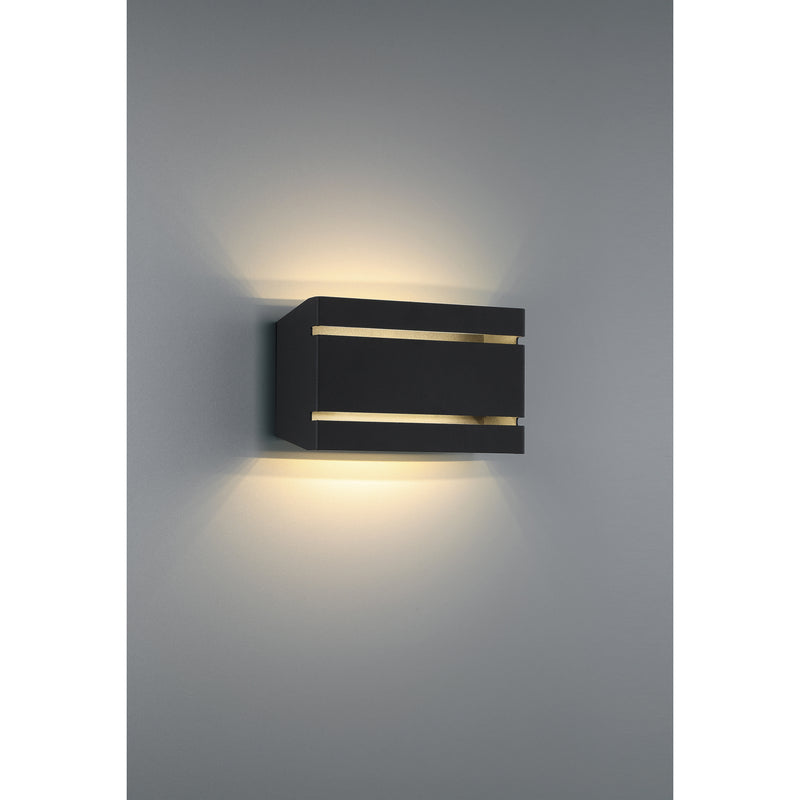 Black outdoor wall light fixture on a gray wall