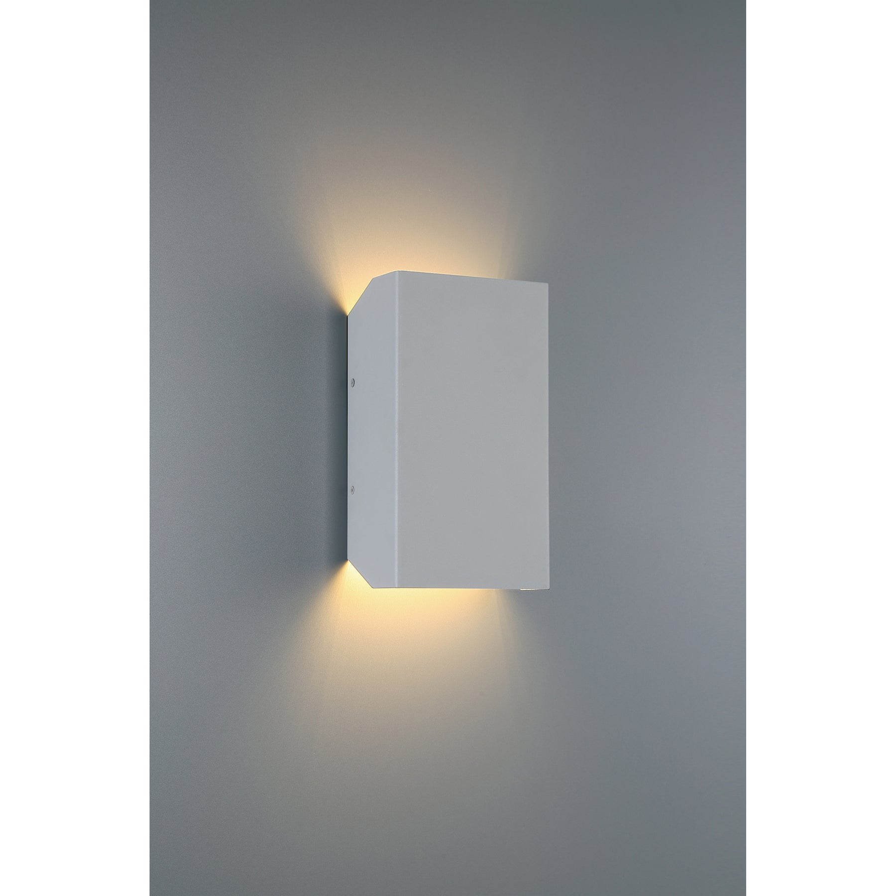 Modern wall-mounted light fixture on a gray wall