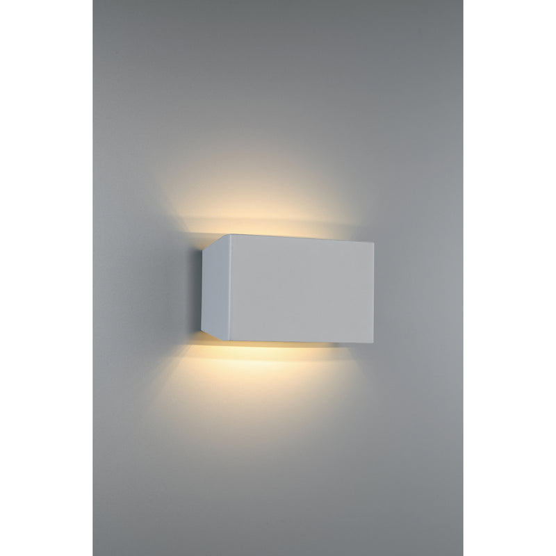Square wall-mounted light fixture on a gray wall