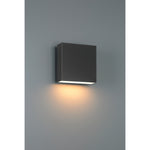 Black square wall light fixture on a gray wall