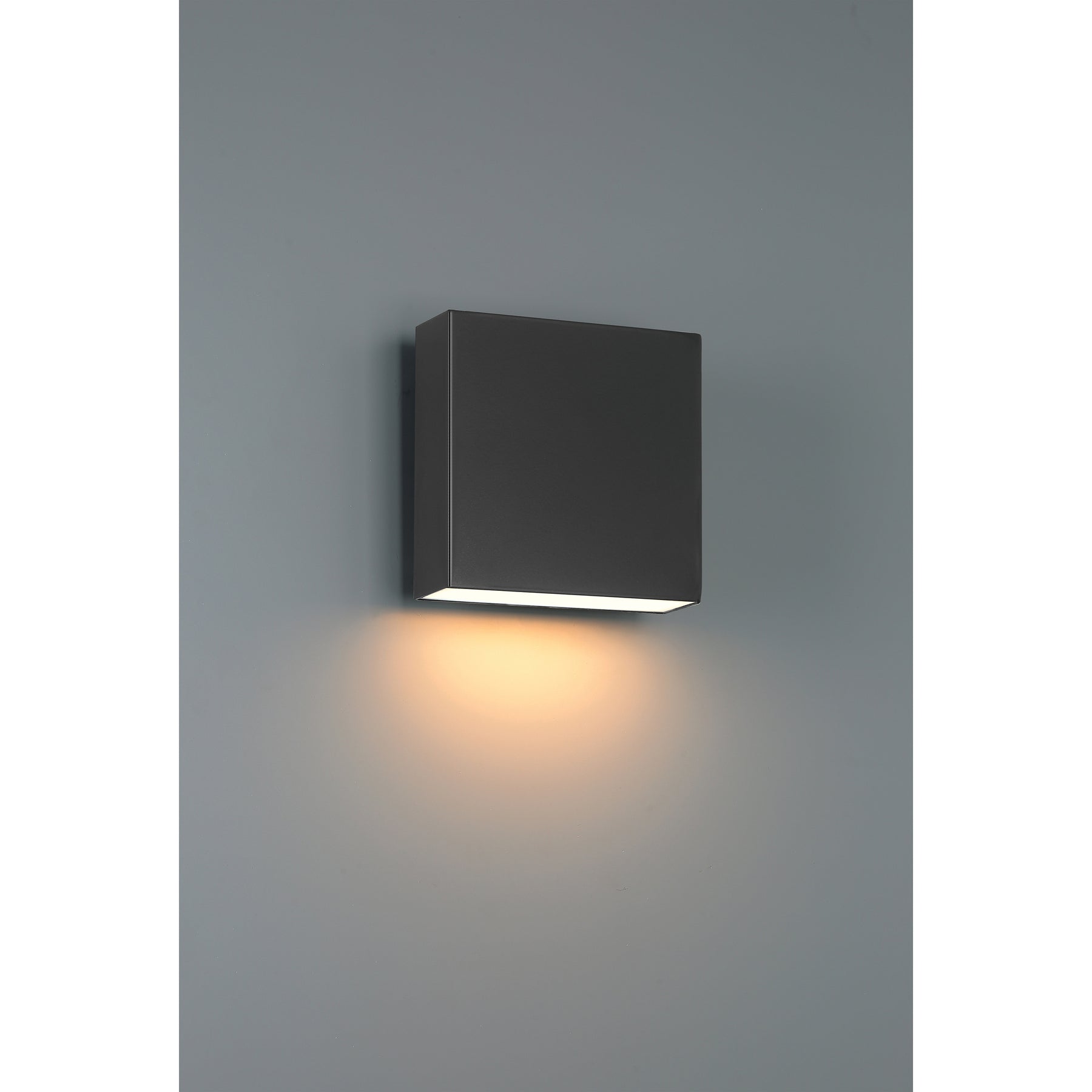 Black square wall light fixture on a gray wall