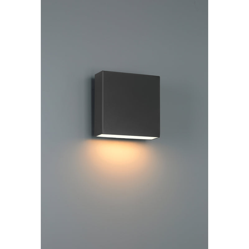 Black square wall light fixture on a gray wall