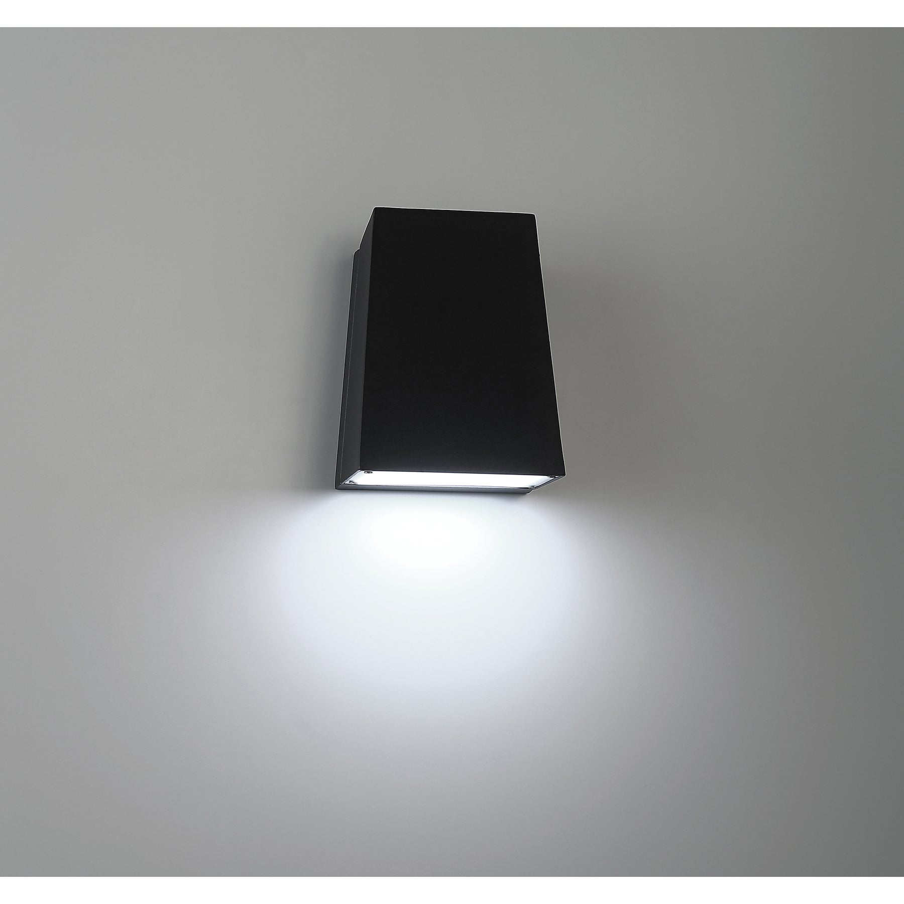 Black rectangular wall light fixture on a gray background