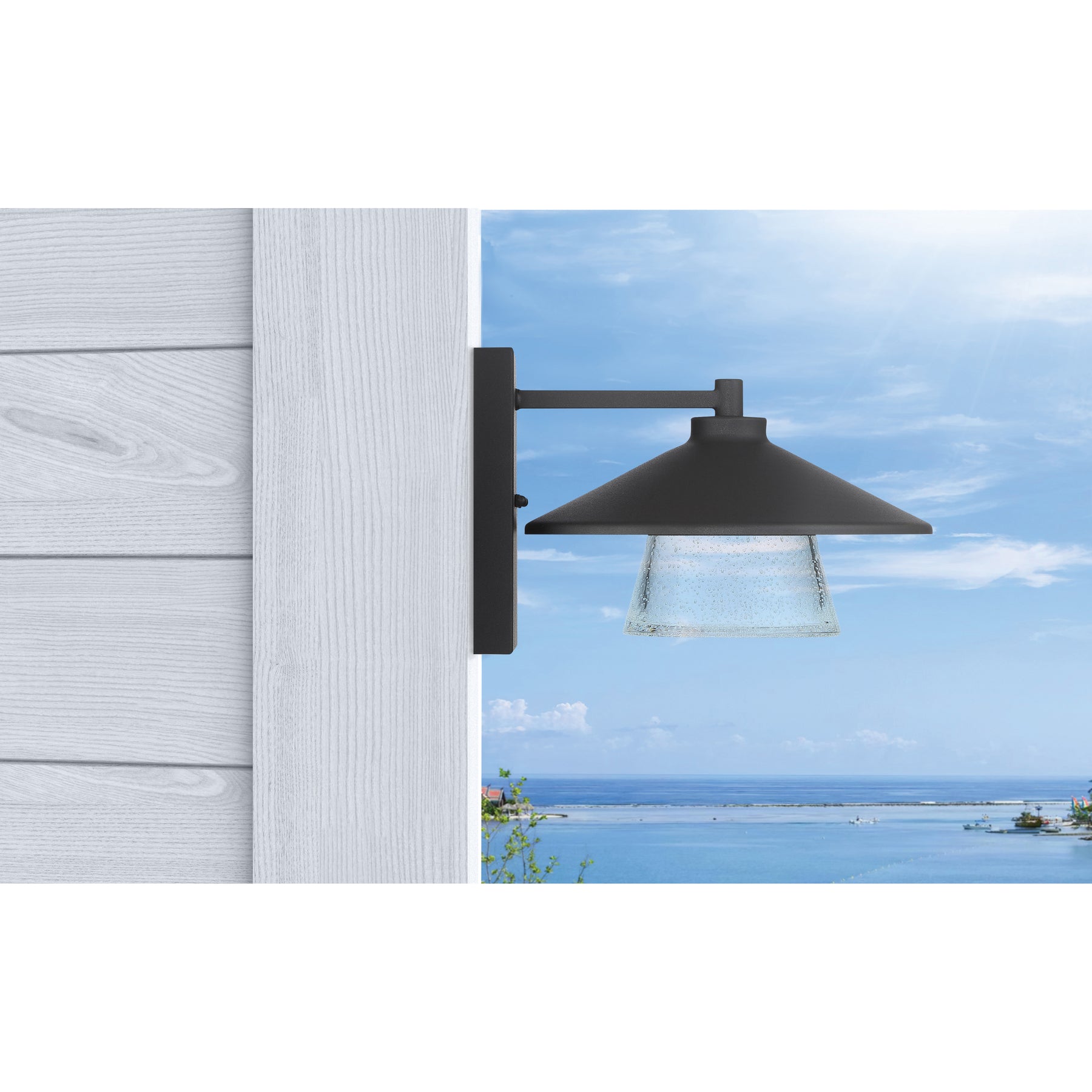 Black outdoor wall light fixture on a wooden post with a scenic background.