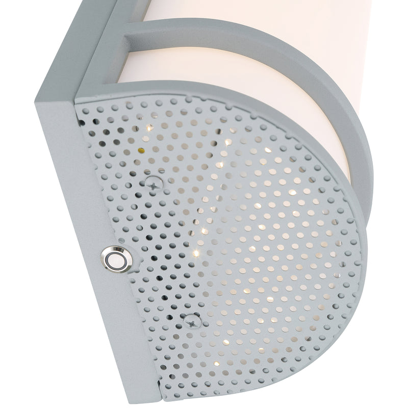 Close-up of a satin wall light fixture with a perforated design on a white background