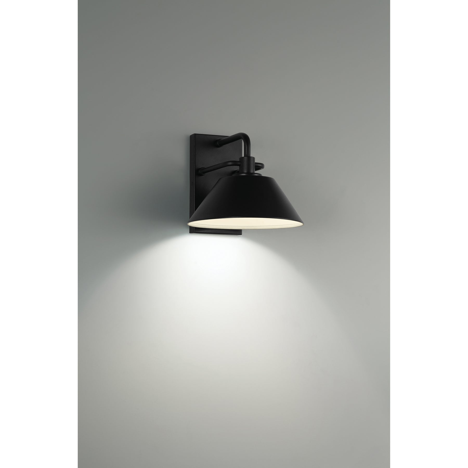Black wall-mounted light fixture on a gray background