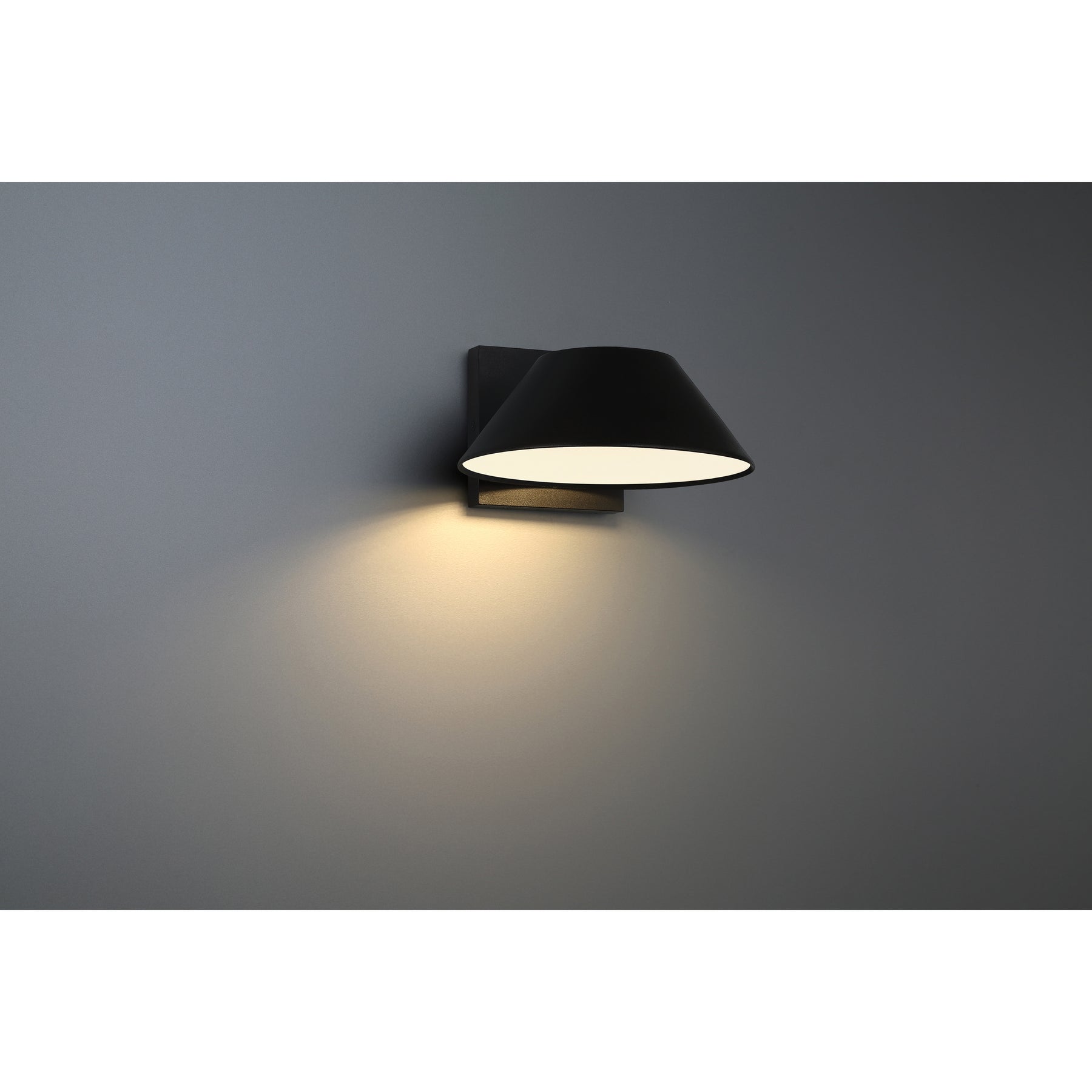 Black wall-mounted outdoor light fixture on a gray background
