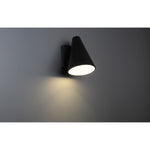 Black wall-mounted light fixture on a gray wall