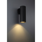 Black cylindrical wall light fixture on a dark gray background