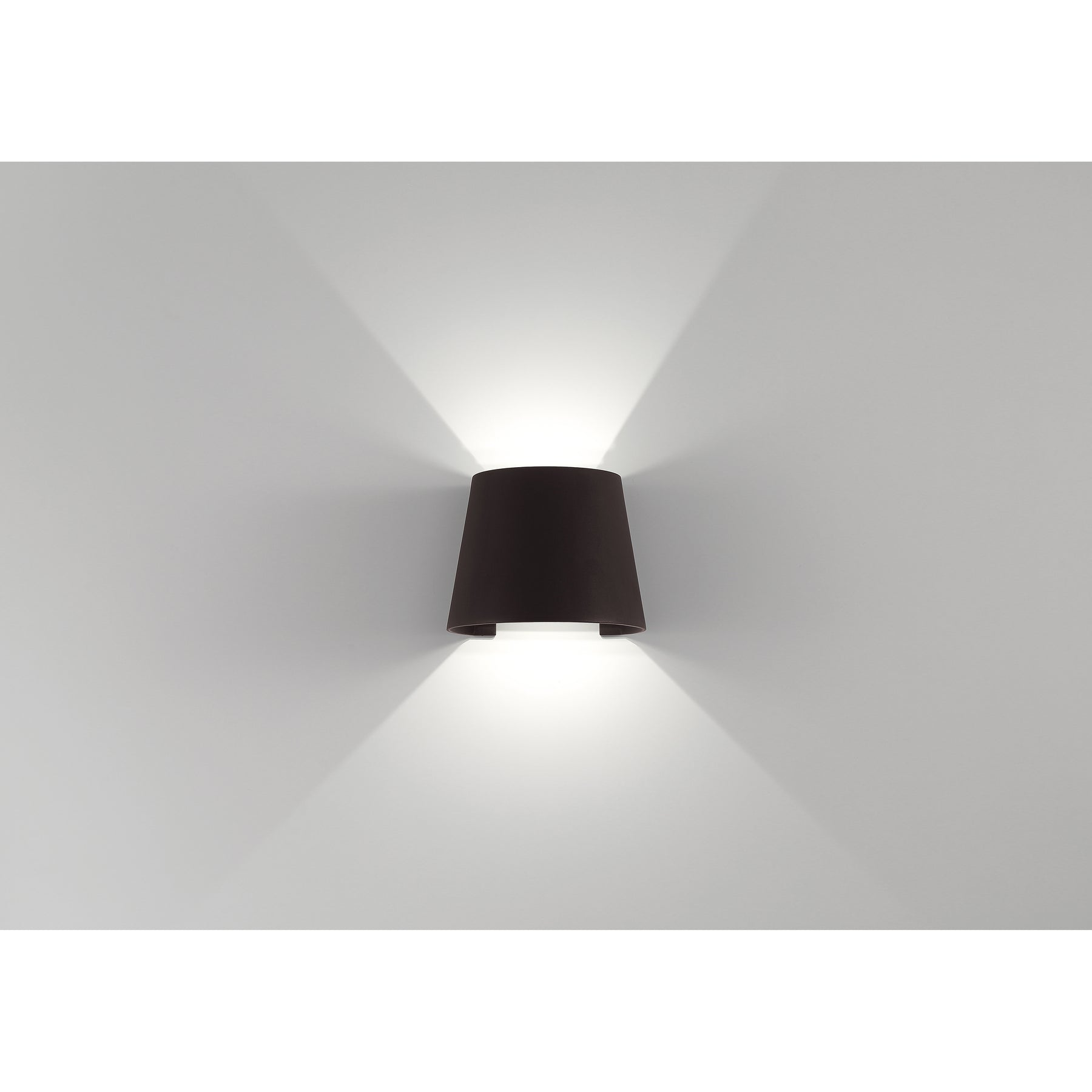 Bronze wall-mounted light on a white wall