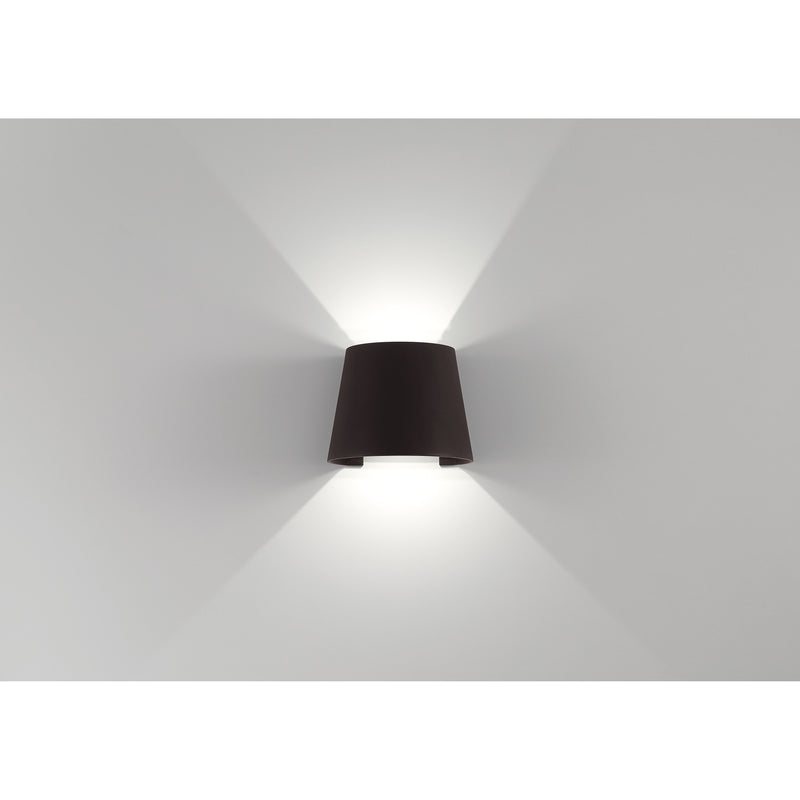 Bronze wall-mounted light on a white wall