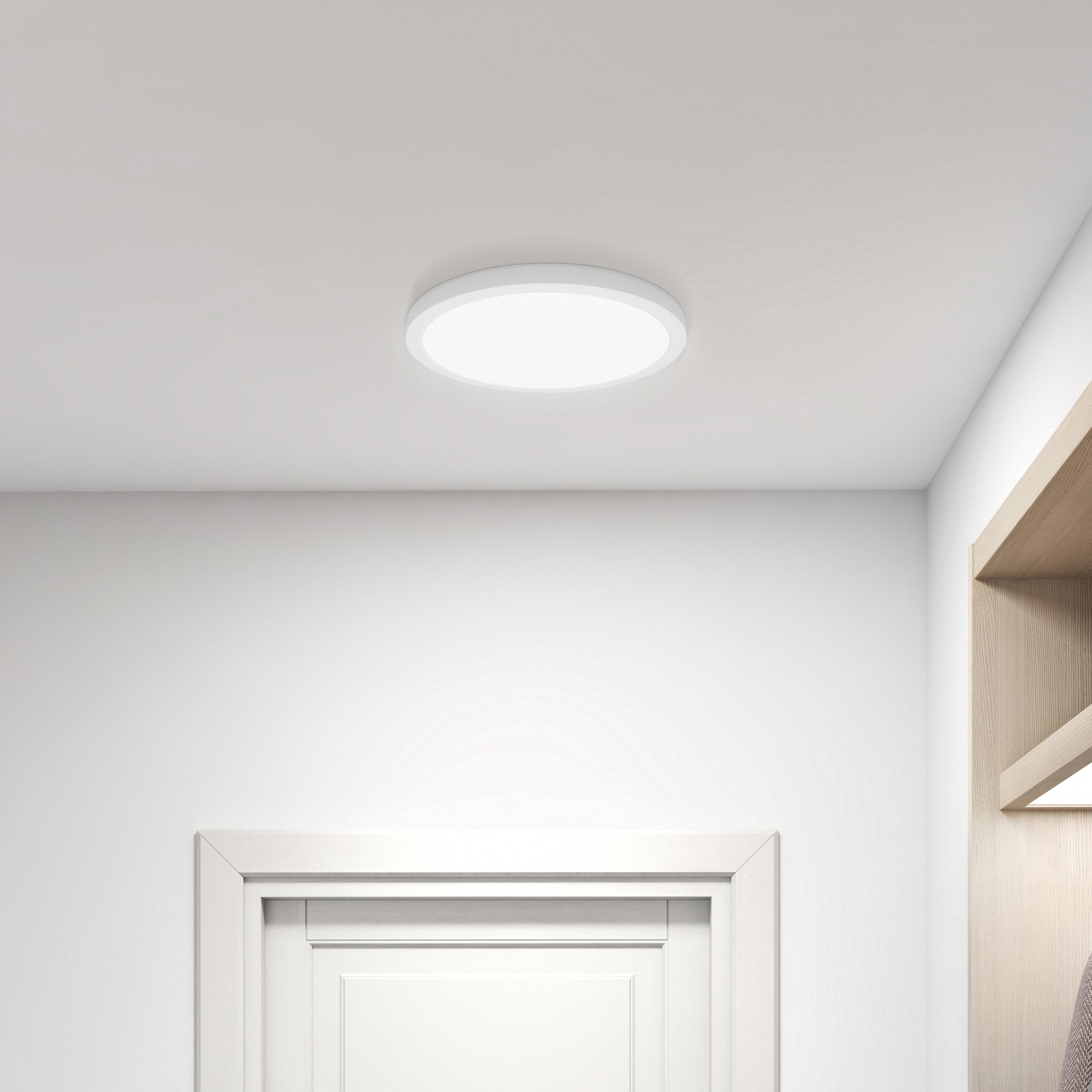 Ceiling light fixture in a room with white walls and a door.