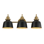 A three-light vanity wall sconce with matte black bell-shaped shades and an antique brass horizontal bar and mounting hardware, shown against a plain white background.