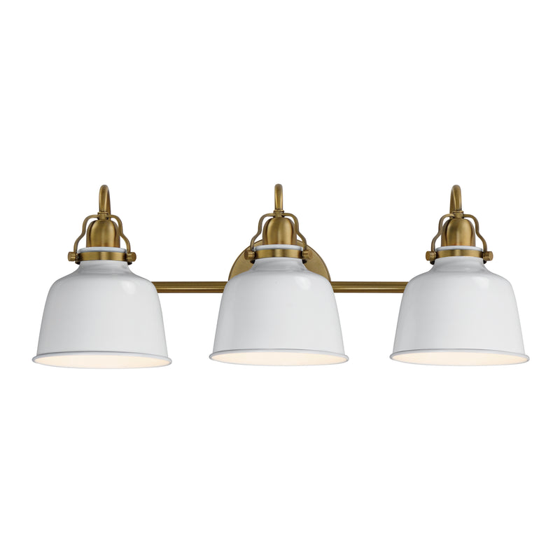 A three-light bathroom vanity light fixture with white dome-shaped glass shades and an antique brass horizontal bar and mounting hardware, shown against a plain white background.