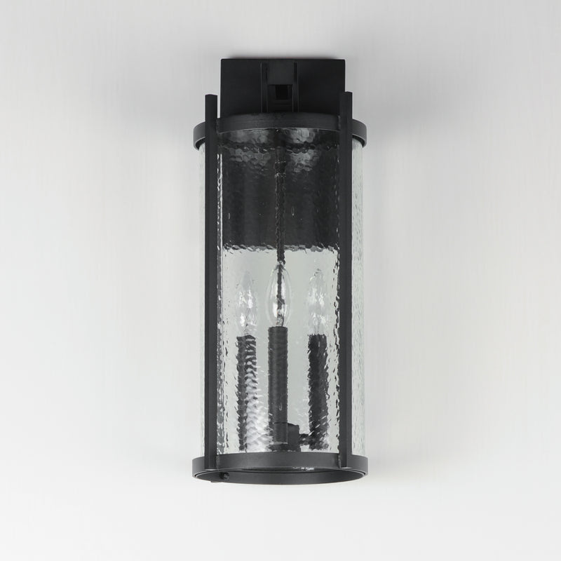 Black outdoor wall light fixture with clear glass cover on a white background