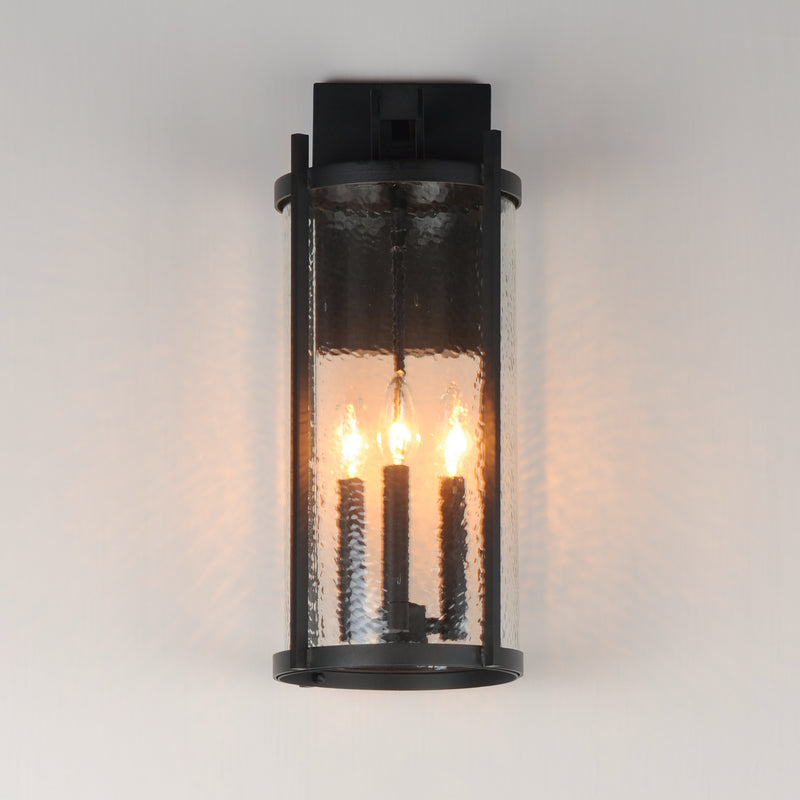 Black outdoor wall light fixture with glass cover on a gray background