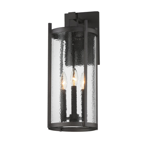 Black outdoor wall light fixture with clear glass on a white background
