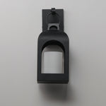 A matte black outdoor wall sconce with a square frame and arched opening, mounted on a light gray wall.