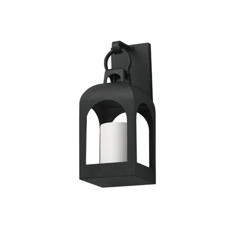 A black outdoor wall sconce with a lantern-style cage design and a white cylindrical candle insert, shown against a plain white background.