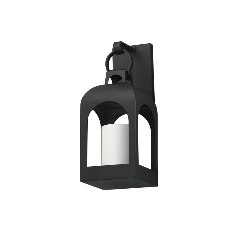 A black outdoor wall sconce with a lantern-style cage design and a white cylindrical candle insert, shown against a plain white background.